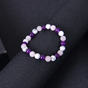 Detail of amethyst, rose quartz, and white turquoise beaded stress relief bracelet