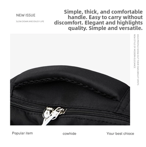 Detail view of reinforced padded handle and metal zippers on black durable travel backpack