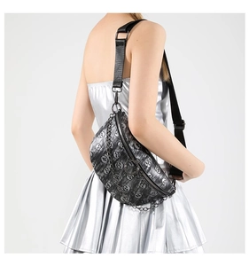 Detail of printed crossbody waist bag featuring skull patterns and silver chain accents