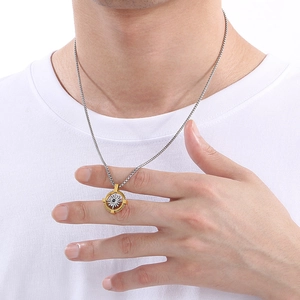 Detailed close-up of a men's stainless steel compass necklace with two-tone star pendant