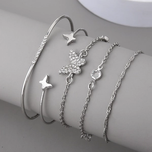 Detailed silver bracelet set featuring rhinestone butterfly and star charms on a stand