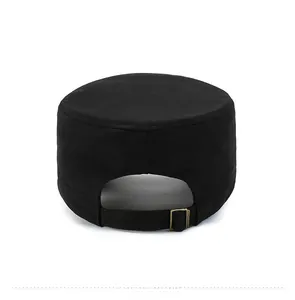 Detail view of the adjustable bronze metal buckle and back strap on a black cadet cap
