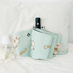 Automatic capybara mint green folding umbrella with sun protection coating on bed