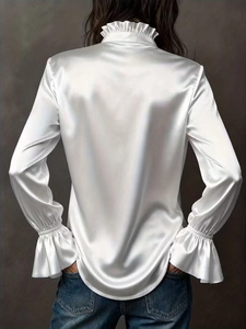 Detail of white satin shirt back with ruffle collar and elegant long sleeves