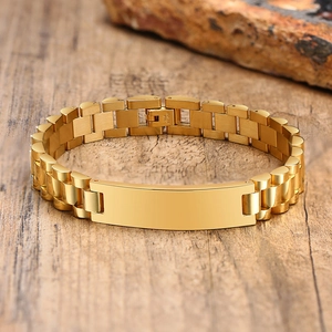 Macro detail of golden stainless steel link bracelet with engravable bar and clasp