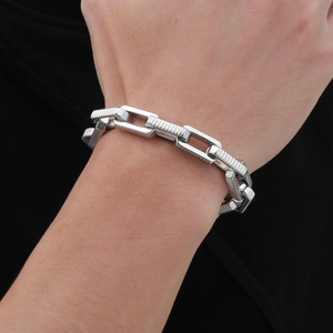 Close-up of men's stainless steel chain bracelet with textured rectangular links