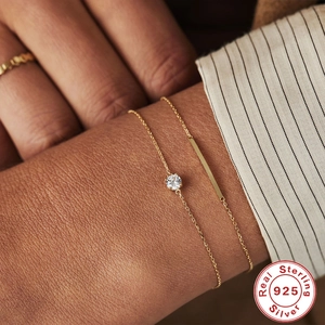 S925 sterling silver gold plated bracelet with solitaire diamond on a model's wrist