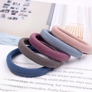 Close-up of seamless elastic hair ties in a palette of five soft Morandi colors
