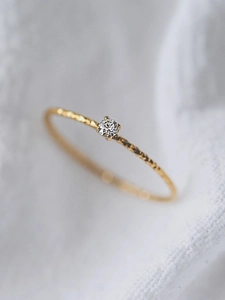 Minimalist hammer textured gold ring featuring a sparkling central round diamond setting