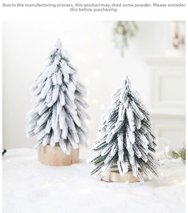 Detail of mini flocked Christmas trees with snow effect and natural wood bases