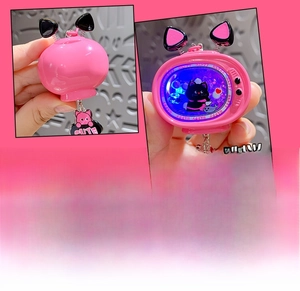 Detailed view of pink TV-shaped cat keychain with glowing feature and sequins inside