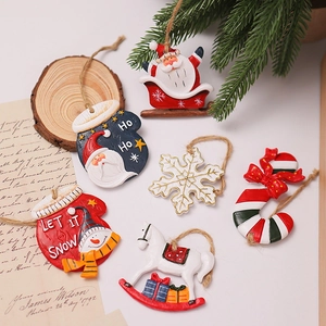 Macro view of vintage resin Christmas ornaments featuring Santa and snowman on pine branches