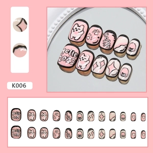 Pink cartoon bear and paw print press-on nails for kids with heart patterns