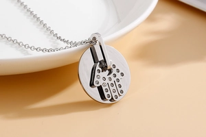 Macro shot of silver Hamsa hand necklace with sparkling crystals on round pendant