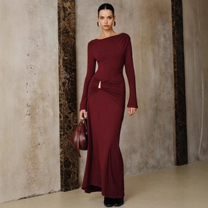 Detail of elegant burgundy knit maxi dress with stylish waist metal ring and ruched design