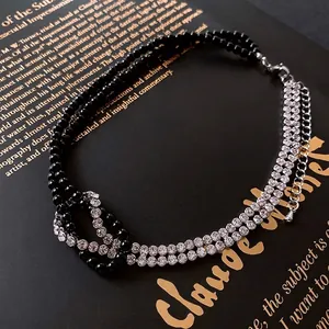 Double-layered beaded choker with sparkling rhinestones and a stylish knotted bow design