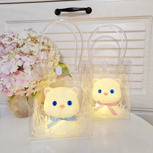 Luminous teddy bear night lights in gift bag with pink and blue bow ties, warm glow