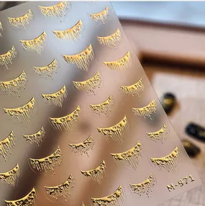 Macro detail of M-971 golden liquid tassel nail art stickers with metallic drip design