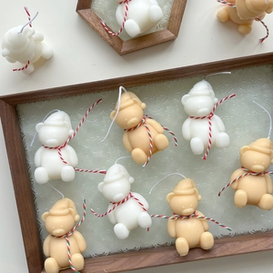 Hand-painted bear-shaped scented candles in cream and yellow for Christmas gifts