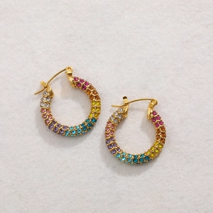Close-up of gold-plated rainbow hoop earrings with multi-colored pavé rhinestones