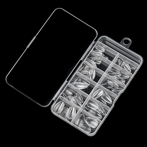 Clear almond shape nail tips set in a transparent divider storage box with black background
