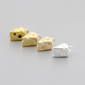 Detailed view of cheese-shaped charms in gold and silver plating for jewelry making