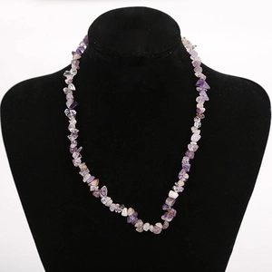 Close-up of handmade natural purple crystal chips necklace on a black mannequin