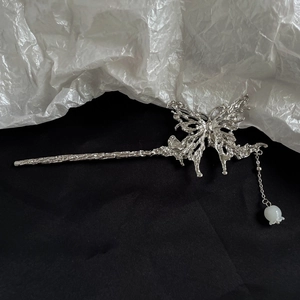 Detail of silver butterfly hair stick with hanging lily of the valley flower charm