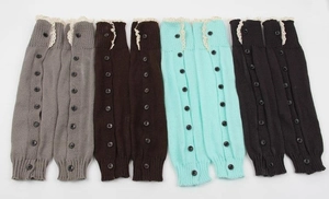 Knit leg warmers featuring delicate white lace trim and decorative black buttons detail