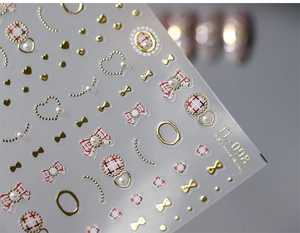 Detailed macro view of TL-098 3D nail stickers featuring gold bows and red heart patterns