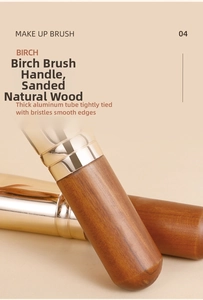 Detail of birch wood brush handle and light gold thickened aluminum tube with wood grain