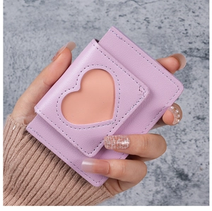 Detail of purple faux leather wallet featuring a heart-shaped cutout and stitched edges