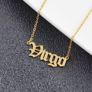 Macro shot of gold stainless steel Virgo necklace with Gothic letter pendant