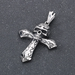 Detailed close-up of a punk style gothic silver skull and cross pendant made of steel