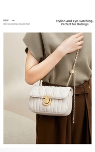 Adjustable golden ball metal chain strap on a white quilted leather flap shoulder bag