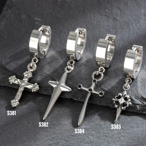 Silver stainless steel punk earrings with cross and star charms on black rock background