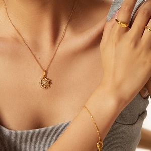 Elegant 18k gold plated stainless steel necklace featuring sun and moon diamond pendant