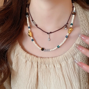Detail of vintage acrylic coffee bean beads and stone pendants on necklace set