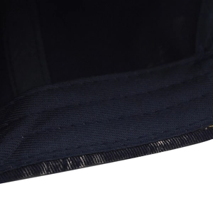 Macro detail of navy washed denim baseball cap brim with durable reinforced stitching