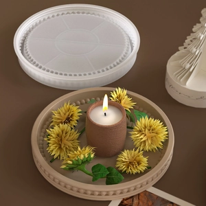 Macro detail of silicone mold and finished beaded tray with candle and sunflower