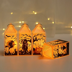 Detail of four Halloween LED lanterns with witch and pumpkin silhouettes for party decor