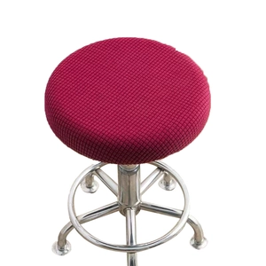 Red plaid round stool cover on a chrome metal high bar stool with a minimalist white background