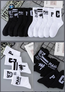 Detail of cotton crew socks featuring black and white graffiti devil cat patterns