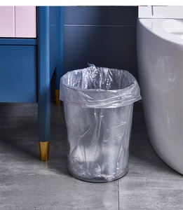 Detailed shot of a transparent round trash bin in a modern bathroom setting