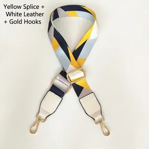 Detail of colorful woven bag strap with white leather ends and gold metal rotating hooks