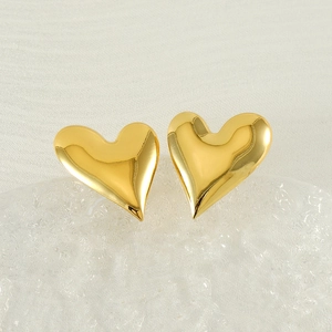 Macro shot of 18k gold plated stainless steel heart earrings with shiny polished finish