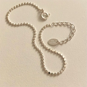 S925 sterling silver flat bead anklet featuring a minimalist chain design with extension