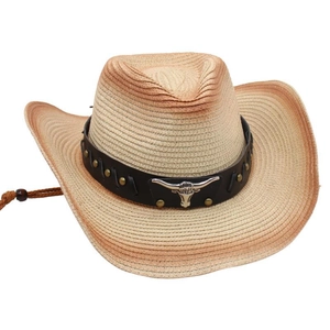 Detail of straw cowboy hat featuring metallic bull head ornament and studded leather band