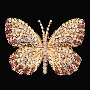 Detailed top view of a gold butterfly brooch with purple rhinestones and white pearls