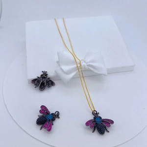 Detailed view of insect pendant necklace with colorful zircon stones in a gift box